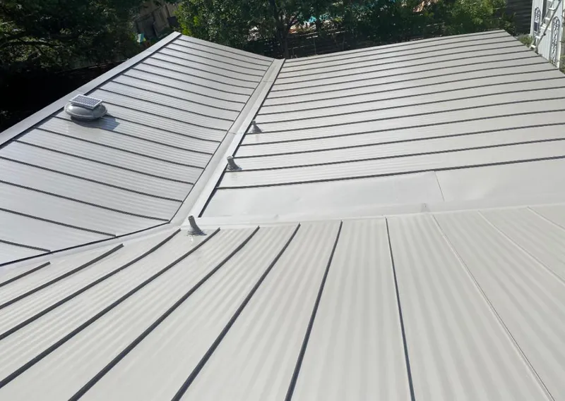 Solar attic fan installed on a metal roof for Roof Ventilation in Scotia